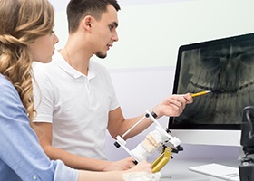 Dentist and patient looking at dental x-rays