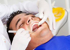 Man receiving oral cancer screening