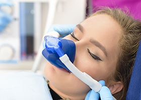 Woman with nitrous oxide administration mask