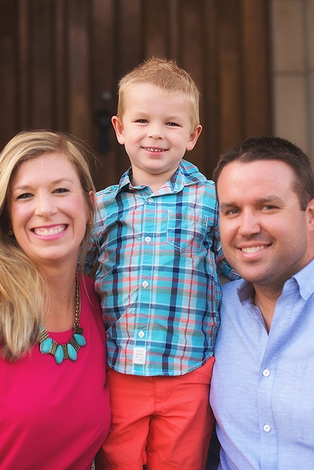 Family of three smiling happily